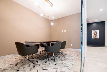 Private conference room available to residents. Complete with a table to seat 6 and elegant, overhead lighting.